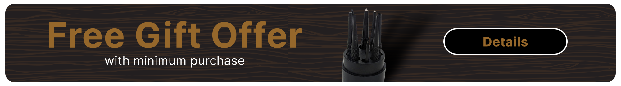 A center punch tool on top of a wooden background.