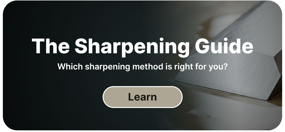 A closeup of a chisel edge on a sharpening stone