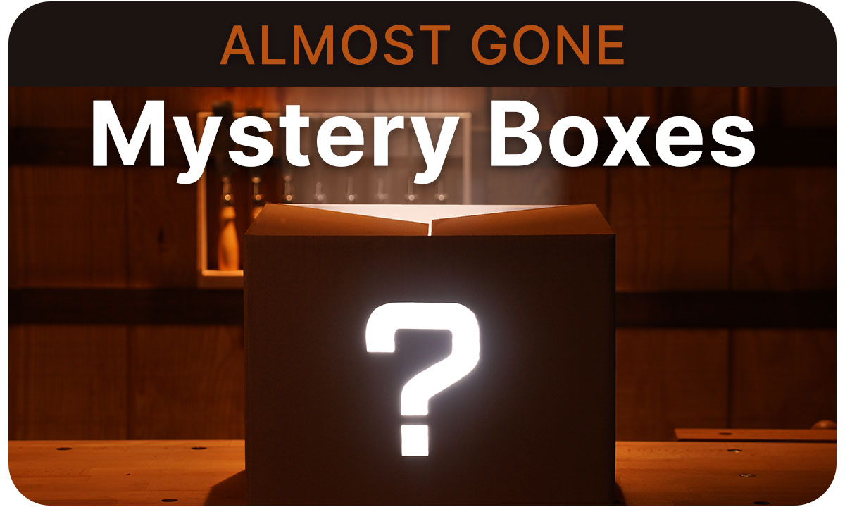 A mystery box sitting on a work bench in dimly lit shop