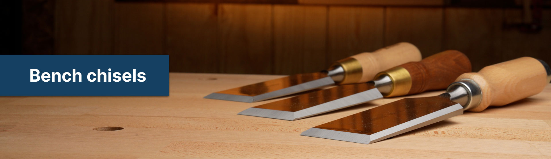 three narex bench chisels on a wooden work bench