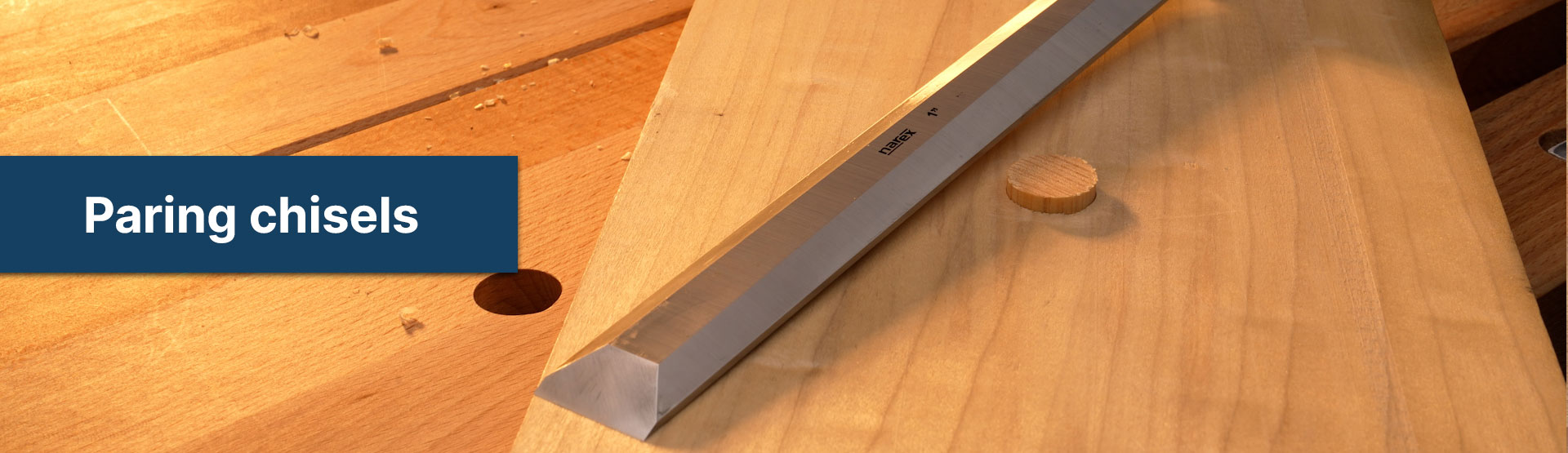 One long paring chisel sitting on a board