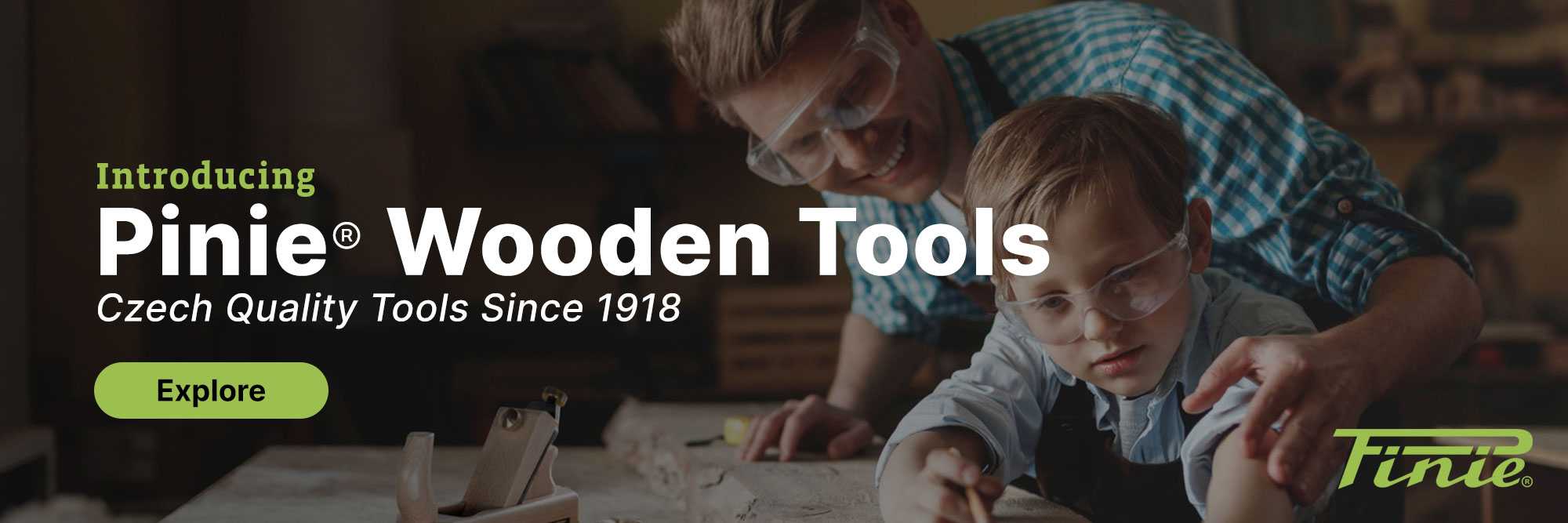 A father helping his son do woodwork on a Pinie work bench